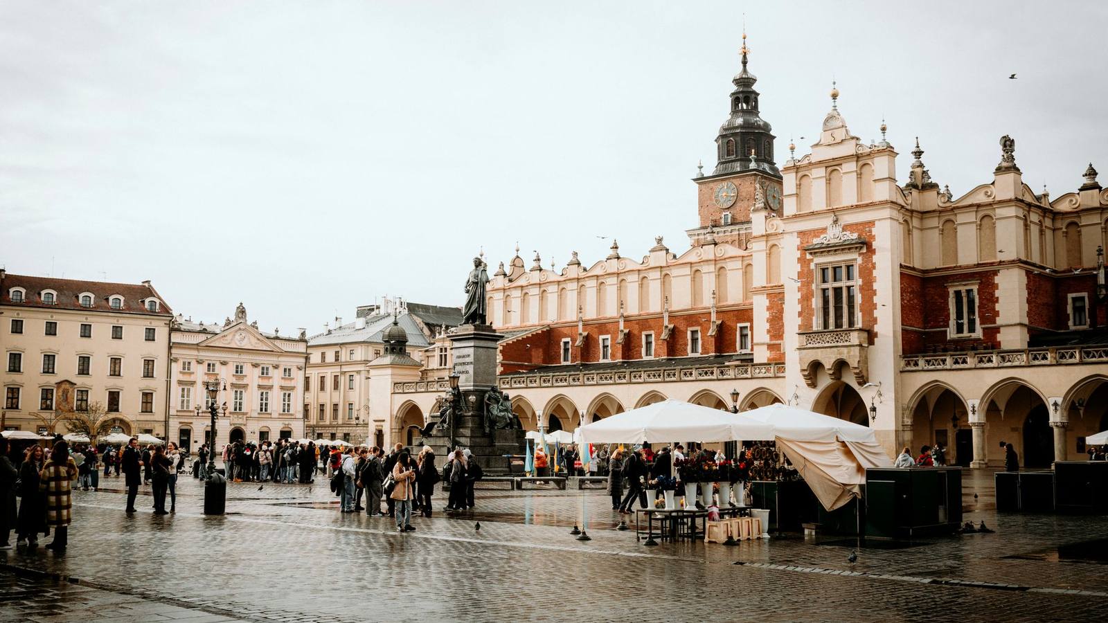 Krakow's Main Market Square with the Cloth Hall and a monument.