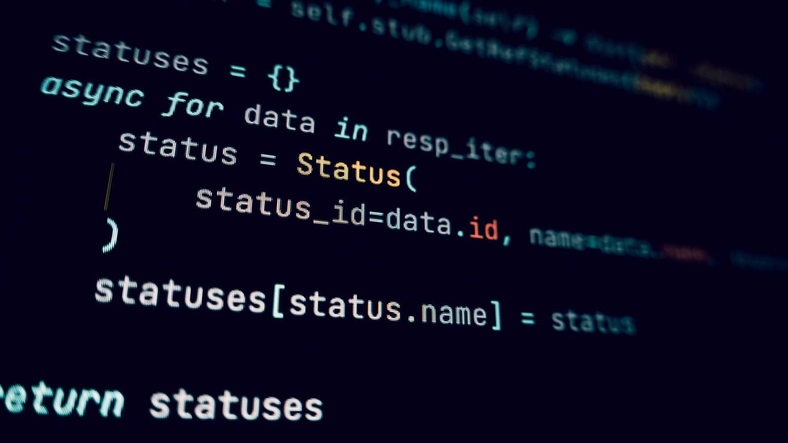 Programming code in a dark-themed editor on a screen.