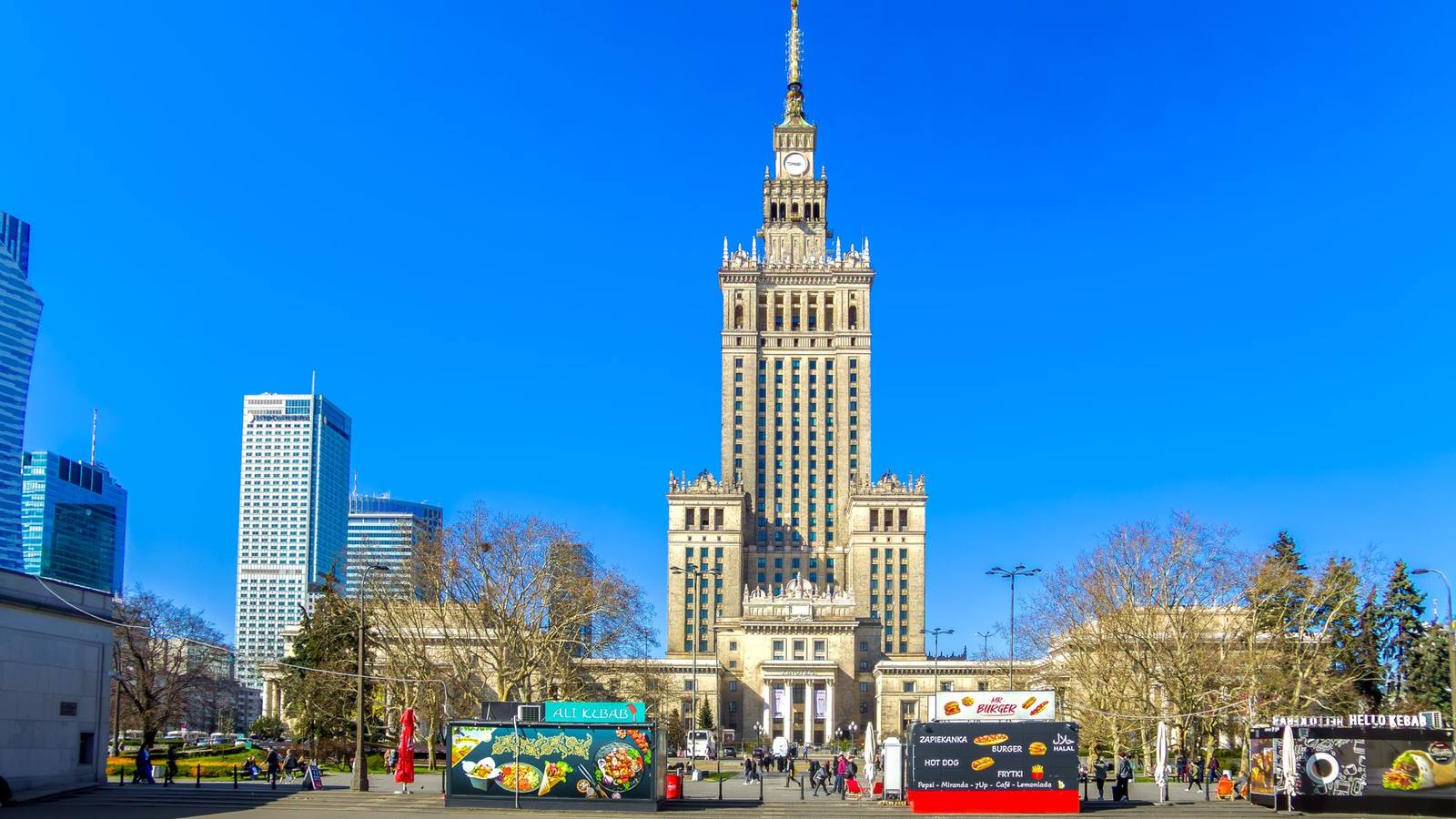 The Palace of Culture and Science in Warsaw under a clear blue sky.
