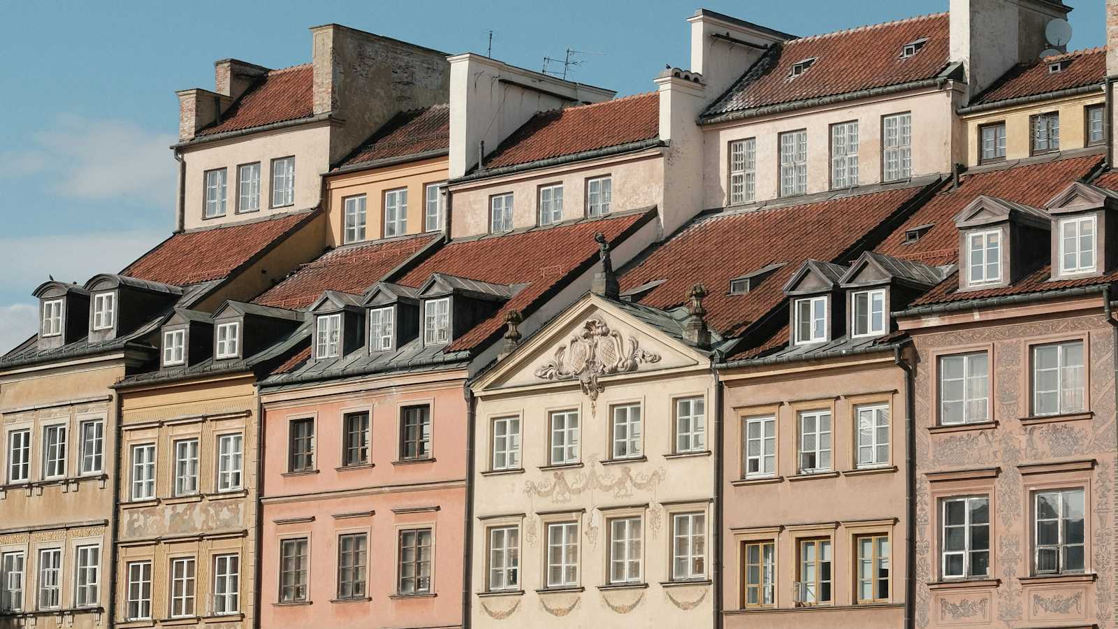Colourful buildings and cafes lining a sunny city square